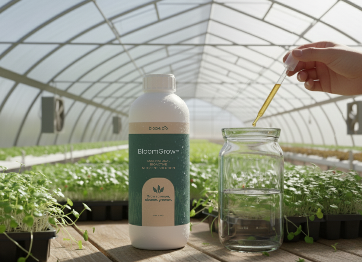 BloomGrow 1 L bottle beside a jar of water being dosed with a dropper in a greenhouse