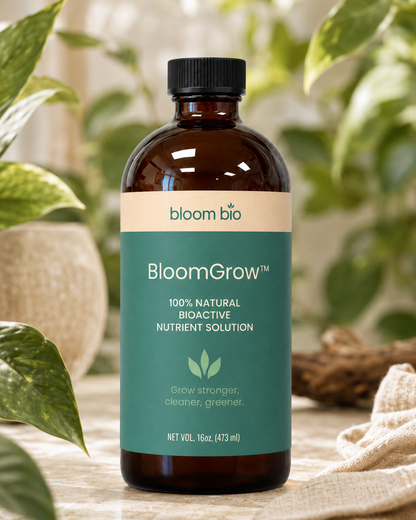 BloomGrow 16 oz (473 ml) amber bottle surrounded by houseplants